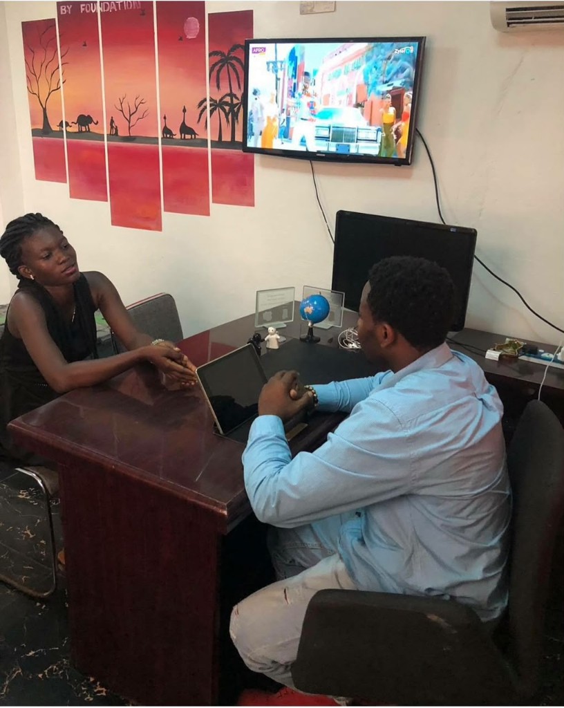 A beneficiary speaking with the foundation team at the office