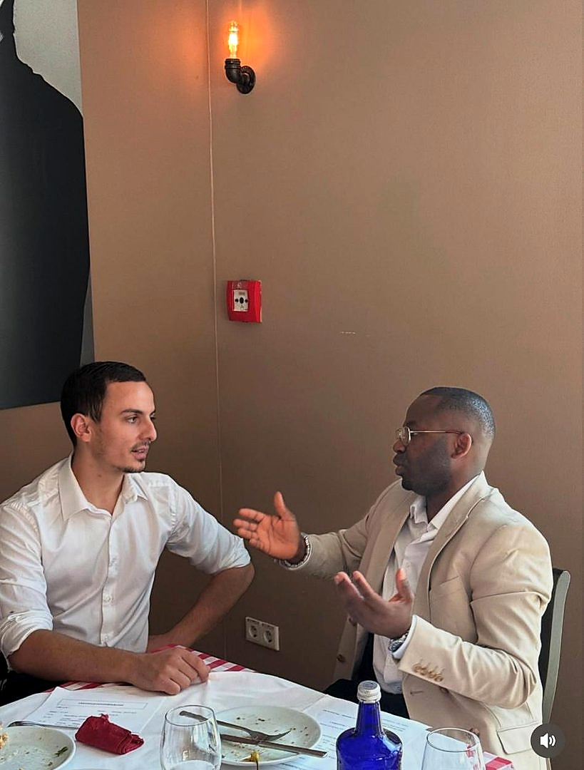 Two people in conversation over a meal