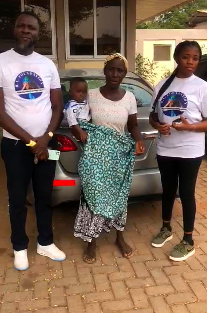 Foundation team members with a mother and child