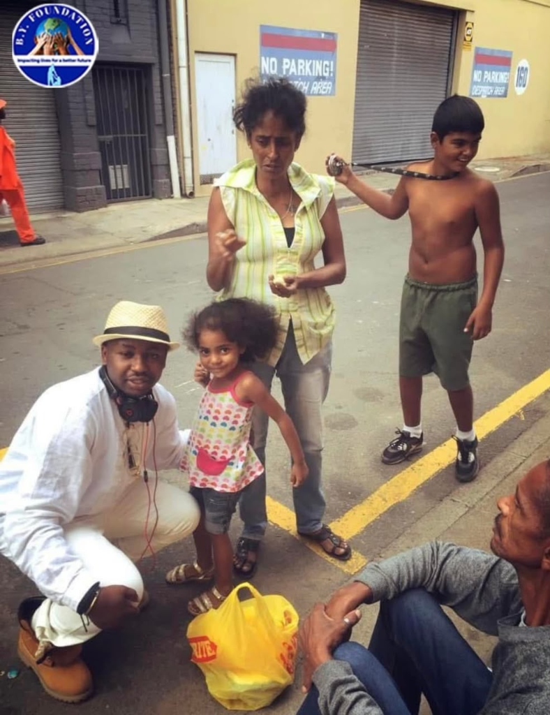 B.Y. Foundation volunteer with a family during street outreach